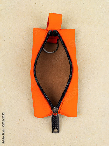 The housekeeper made of genuine leather lies on the table on paper