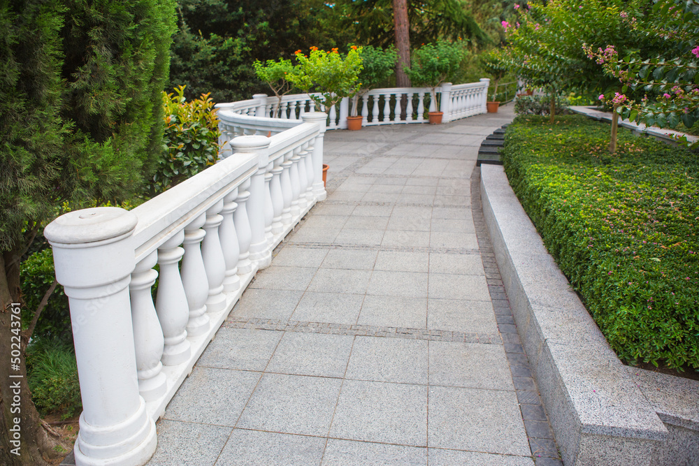 Walking path with a parapet in a beautiful square Walking path with a parapet in a beautiful square
