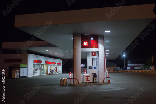 Tablou pe pânză Illuminated gas station at night.