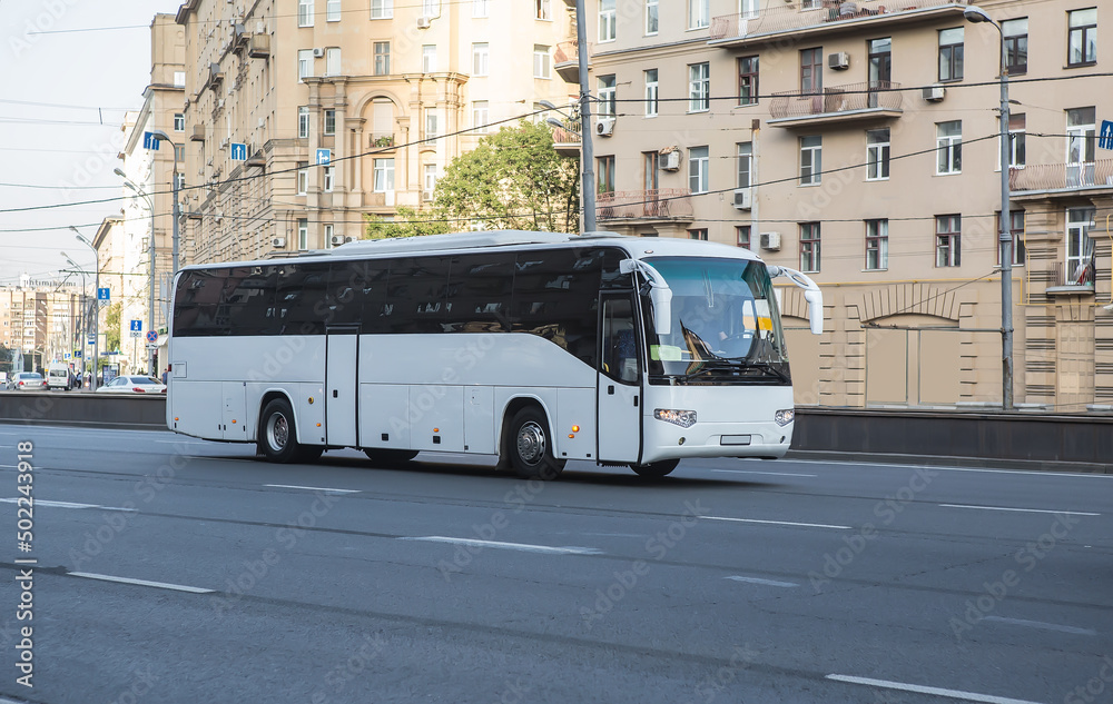 Fototapeta premium Tourist bus moves along the street