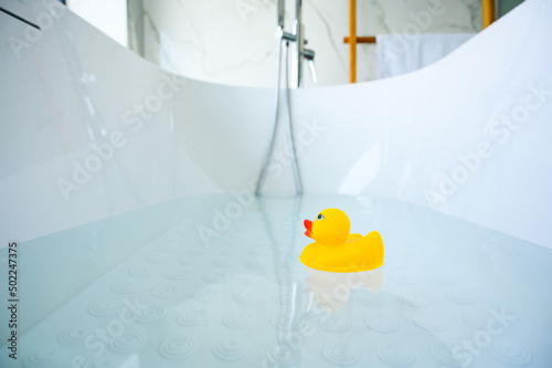 Obraz na plátně Yellow playful rubber duck float in the bathtub