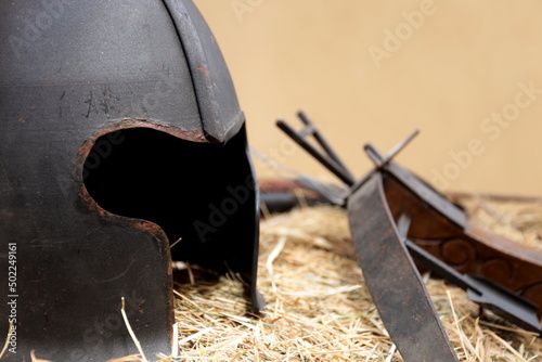 Fotobehang Medieval helmet and crossbow resting on the hay.