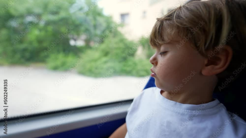 Small boy traveling by bus passenger kid travs by public transportation looking out window Small boy traveling by bus passenger kid travs by public transportation looking out window