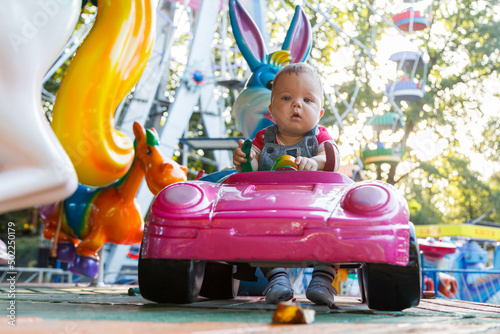 handsome little boy on amusement ride machine