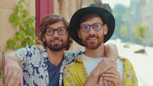 Cute portrait young two gay men with glasses look to side lovely feel happy homosexual couple dating LGBT relationship love smiling outdoors boyfriend attractive slow motion photo