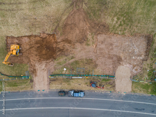 Construction site with digger levelling out ground for house build