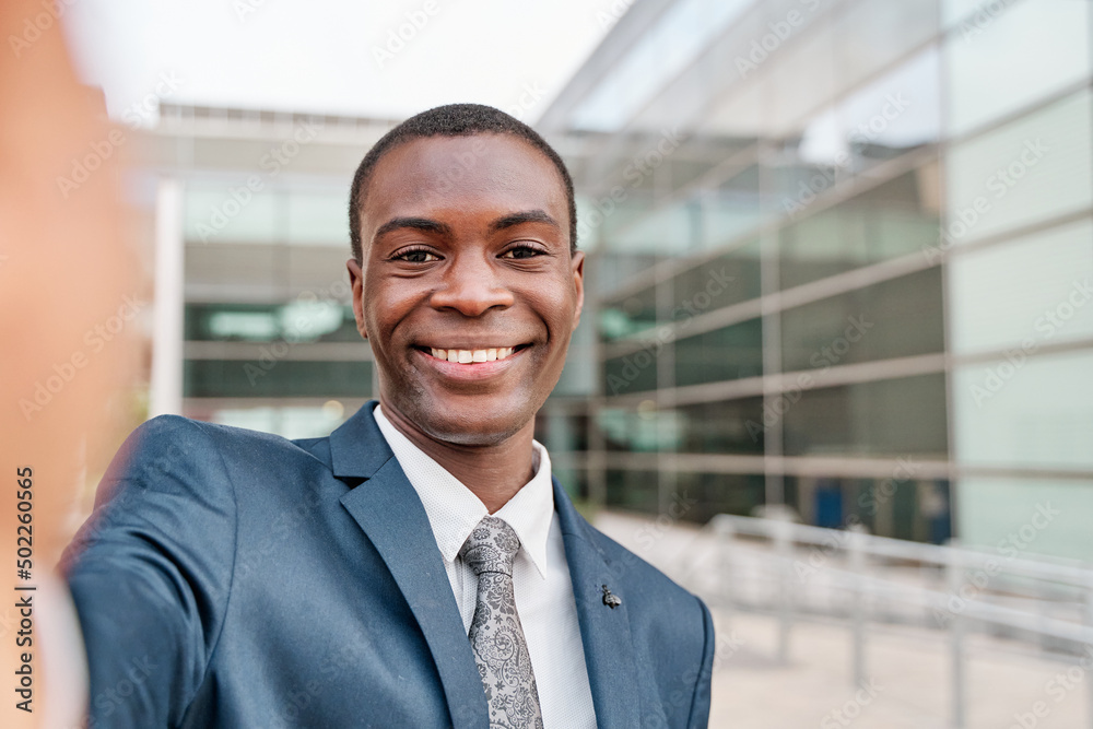 Young african american businessman dressed in formal suit taking selfie outside job center smiling Young african american businessman dressed in formal suit taking selfie outside job center smiling