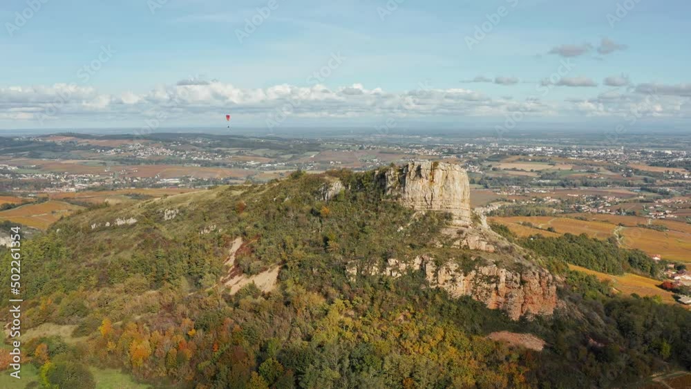 Rock of Solutré - limestone escarpment west of Mâcon, France, overlooking the commune of Solutré-Pouilly. Aerial view. Rock of Solutré - limestone escarpment west of Mâcon, France, overlooking the commune of Solutré-Pouilly. Aerial view.