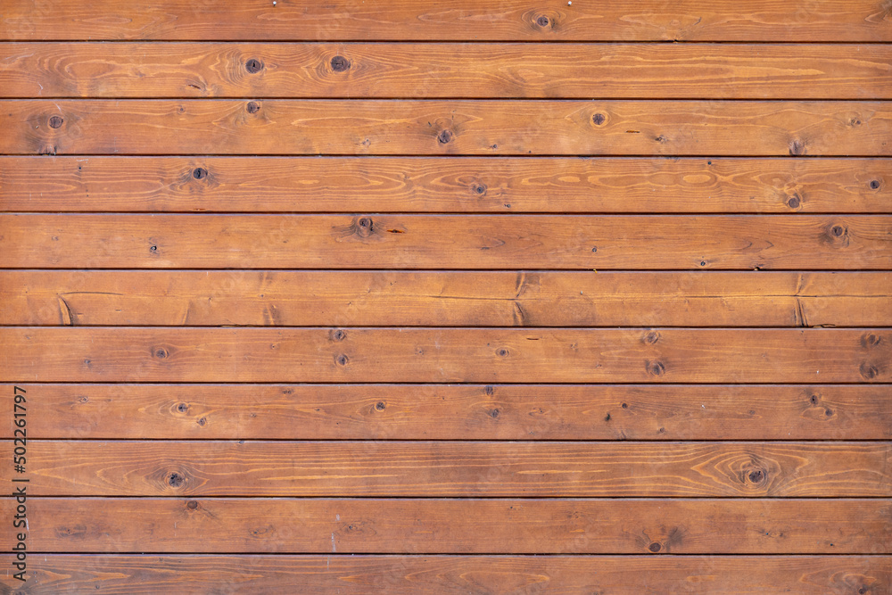 Wood texture background. Timber planks in horizontal direction. Natural backdrop of a building exterior with small dirt spots. Weathered facade in good condition. Wood texture background. Timber planks in horizontal direction. Natural backdrop of a building exterior with small dirt spots. Weathered facade in good condition.
