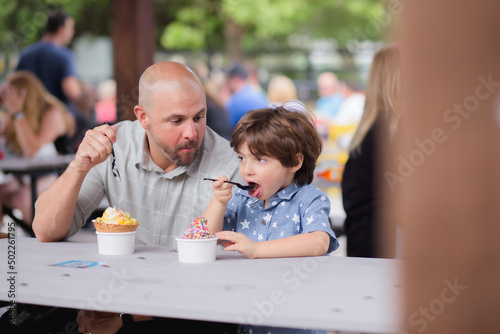 Dad and son buying and eating ice-cream in boxi parkin lake nona florida 