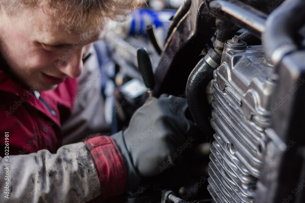 a man repairs a motorcycle, motorcycle maintenance. a man repairs a motorcycle, motorcycle maintenance.