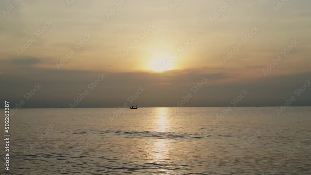 sunrise over beach waves wash sand beach with boat take cruise in sea. Red sky, yellow sun and amazing summer sea with tropic nobody nature seascape video. The sun in spindrift clouds natural sunset sunrise over beach waves wash sand beach with boat take cruise in sea. Red sky, yellow sun and amazing summer sea with tropic nobody nature seascape video. The sun in spindrift clouds natural sunset