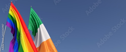 Photography LGBT and Ireland flags on flagpole on blue background