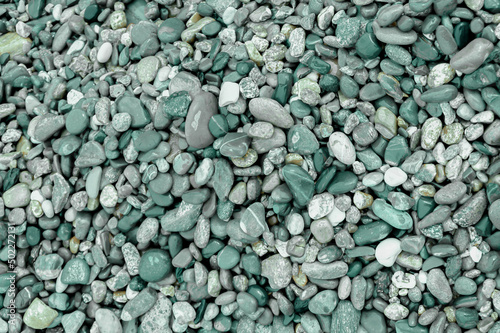 texture background of helki stones. green stones, trendy green background. colors of 2022. free space for text