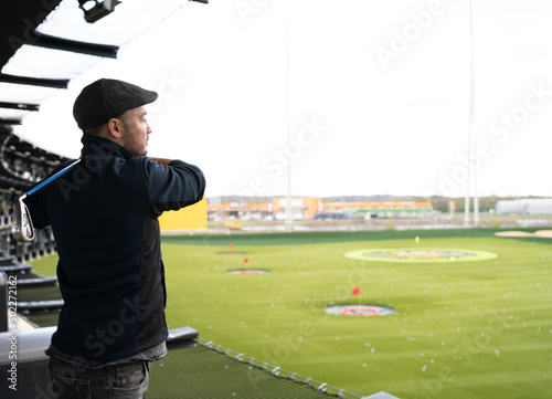 Man playing golf in modern golf location