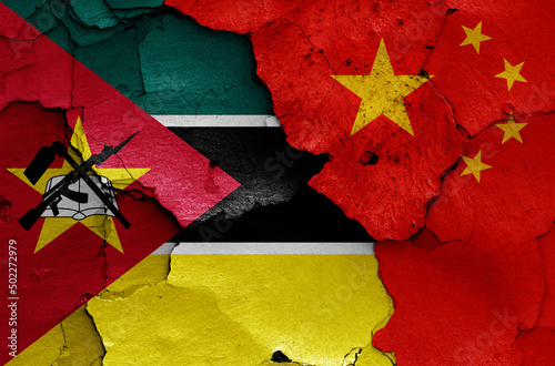 flags of Mozambique and China painted on cracked wall