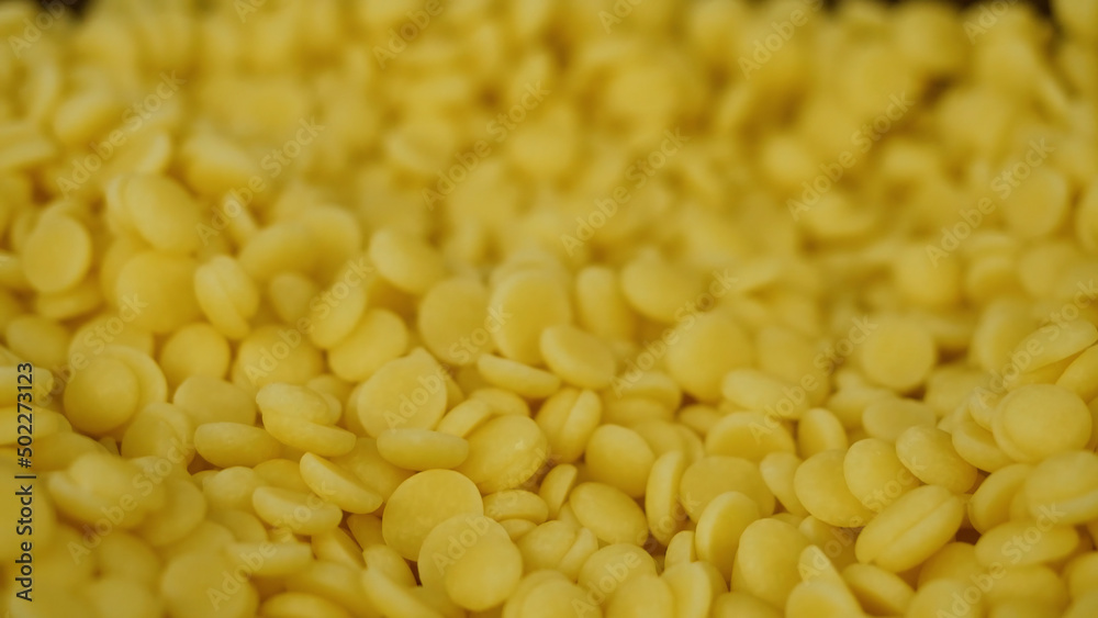 Yellow pills for dessert. Yellow dragees for cake, closeup