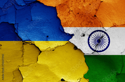 flags of Ukraine and India painted on cracked wall