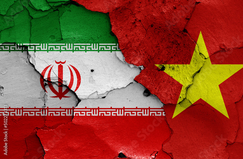 flags of Iran and Vietnam painted on cracked wall