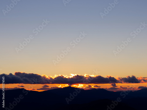 Mountain ridge at sunset with clouds