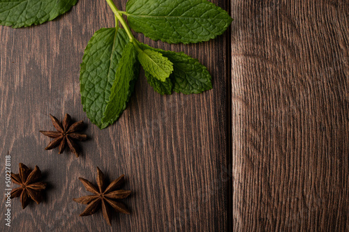 Mint and star anise on a dark wood background