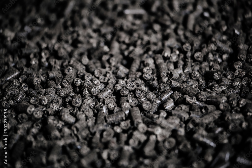 Black bio fuel pellets, close up view, selective focus Black bio fuel pellets, close up view, selective focus