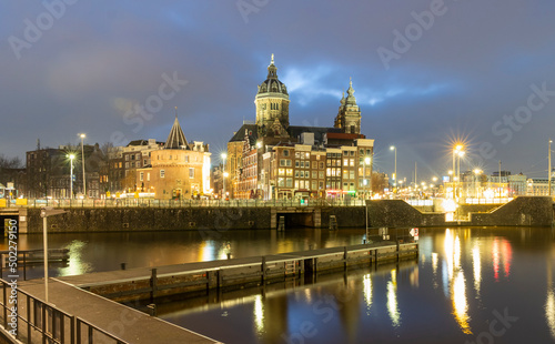 Amsterdam Netherlands on December 13, 2021: City scenic from Amsterdam at the Amstel in the Netherlands at night. Amsterdam Light Festival Boat Tour in Christmas.