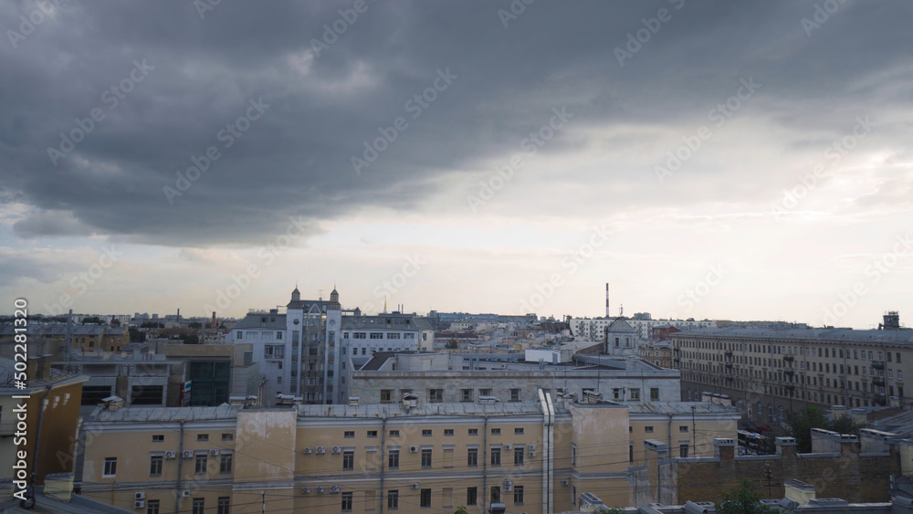 Panorama of old town with gray roofs in cloudy weather. Action. Historical and unremarkable center of city with old architecture of houses. Old town looks depressing and sad in cloudy weather