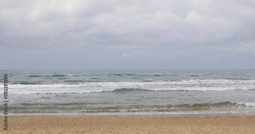 The waves of the sea break on the shoreline of the beach. The waves of the sea break on the shoreline of the beach.