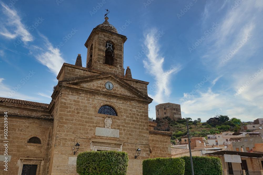 Vélez de Benaudalla (Granada, Spain): church in the foreground and medieval castle of the Ulloa on a hill in the background