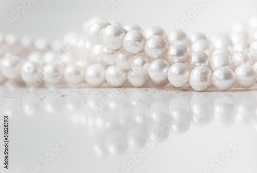 Nature white string of pearls on marble background in soft focus