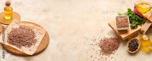 Composition with flax seeds, oil and spices on grunge background photo