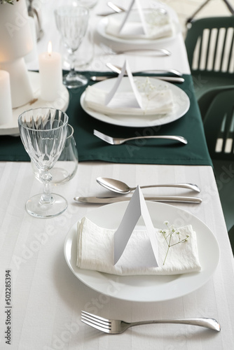 Stylish table setting for wedding celebration in dining room