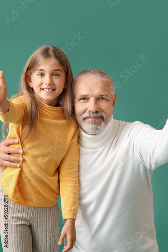 Little girl with her grandf...