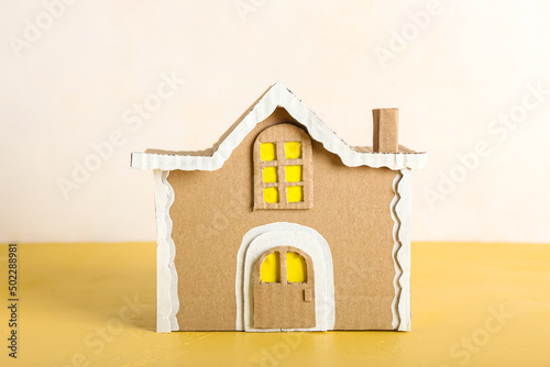 Cardboard house on table ag...