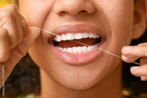 African-American teenage girl flossing teeth  closeup