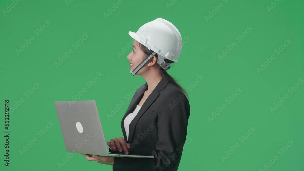 Side View Of Smiling Asian Female Engineer Looking Around And Shaking Her Head While Using Laptop In The Green Screen Studio
Side View Of Smiling Asian Female Engineer Looking Around And Shaking Her Head While Using Laptop In The Green Screen Studio
