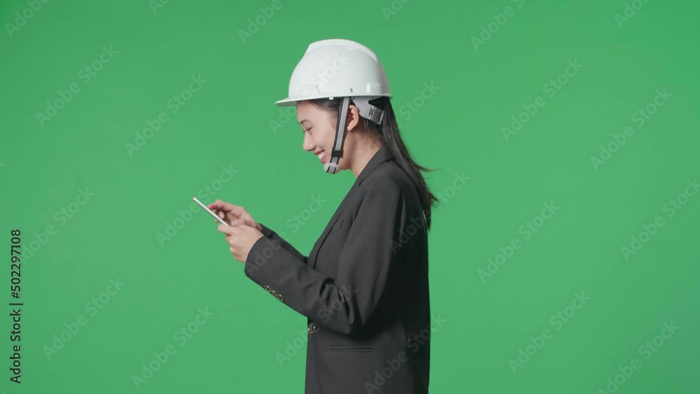 Side View Of Smiling Asian Female Engineer Looking Around And Shaking Her Head While Using Tablet And Walking In The Green Screen Studio
Side View Of Smiling Asian Female Engineer Looking Around And Shaking Her Head While Using Tablet And Walking In The Green Screen Studio