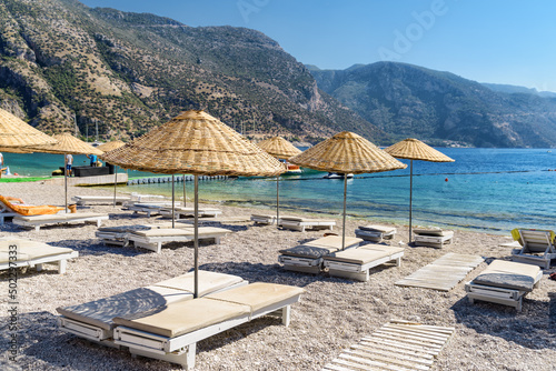 Beach umbrellas and sun loungers on Oludeniz Beach in Turkey