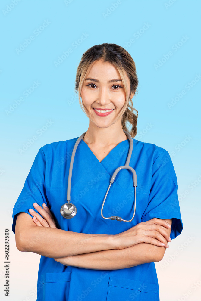 Portrait of female doctor dressed in blue crossing her arms and smiling confidently. Portrait of female doctor dressed in blue crossing her arms and smiling confidently.