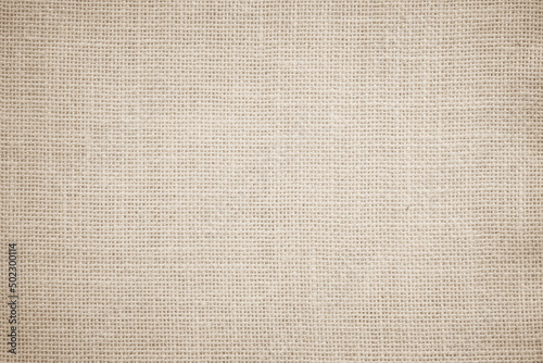 Jute hessian sackcloth burlap canvas woven texture background pattern in light beige cream brown color blank. 