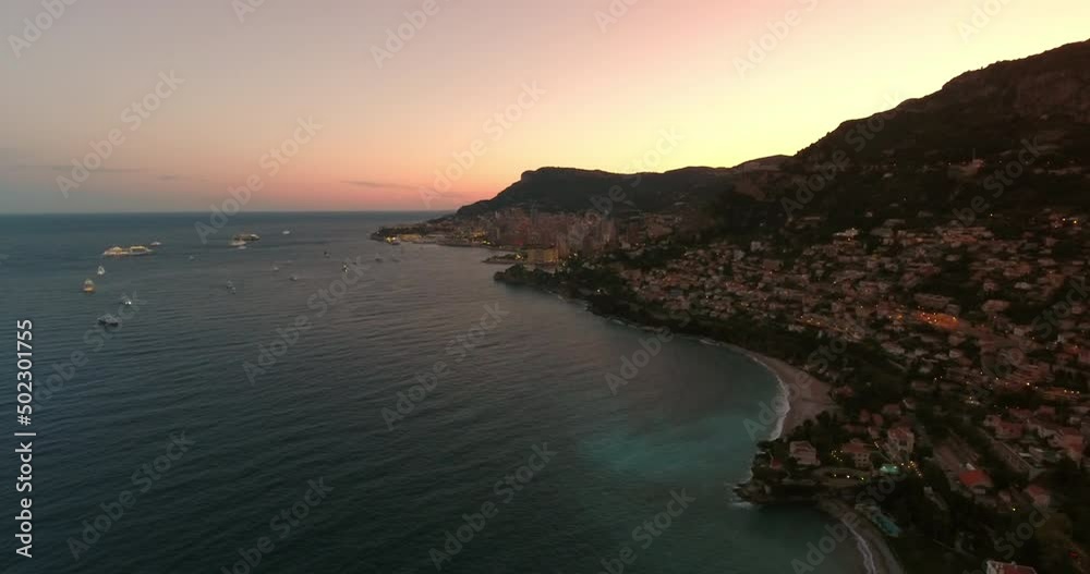 Aerial Tilt Up Beautiful Shot Of City On Mountain Landscape, Drone Flying Over Sea During Sunset - Monaco Aerial Tilt Up Beautiful Shot Of City On Mountain Landscape, Drone Flying Over Sea During Sunset - Monaco