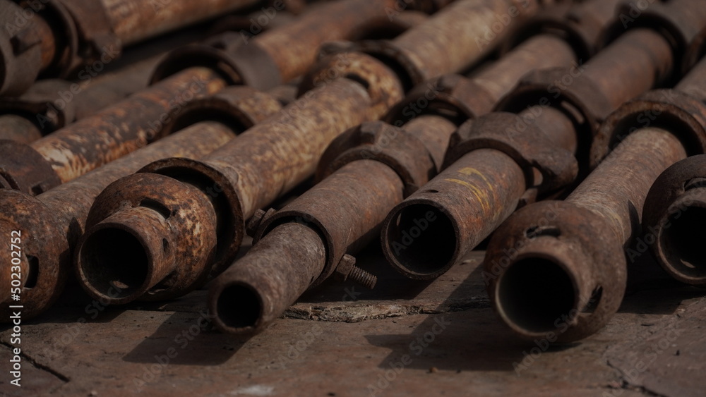 Stack of iron pipes at construction site