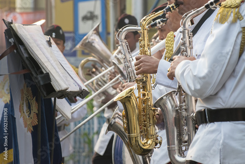 KOLKATA, WEST BENGAL , INDIA - JANUARY 17TH 2016 : Kolkata Police Force Officers, dressed in white and black suits, are playing band, using various musical instruments, in a winter morning.