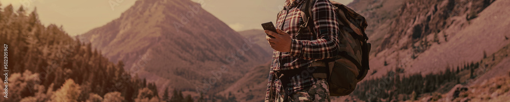 Men using digital phone in the mountains
