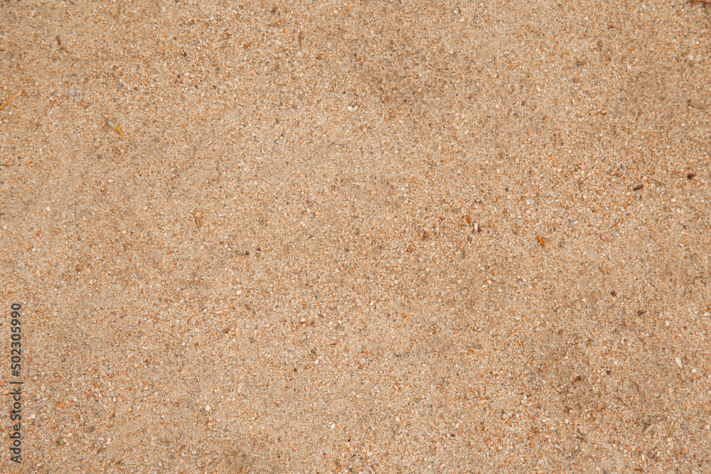 A closeup horizontal image of sand grain background dirt texture. A closeup horizontal image of sand grain background dirt texture.
