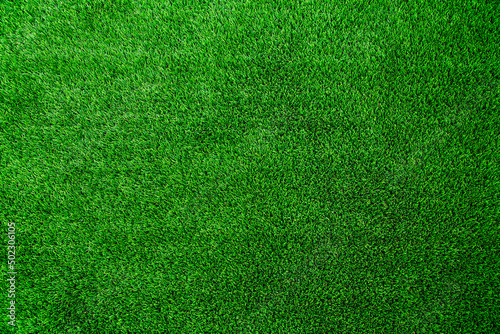 A background texture image of real green AstroTurf artificial grass.  photo