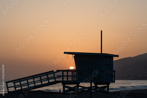 Beautiful Zuma Beach sunset with the lifeguard station n the foreground, Malibu, California