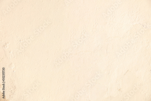 Old beige color paint faded wall texture background. Peeled house facade, front view © Rawf8