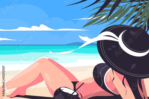 Girl laying on beach in hat
